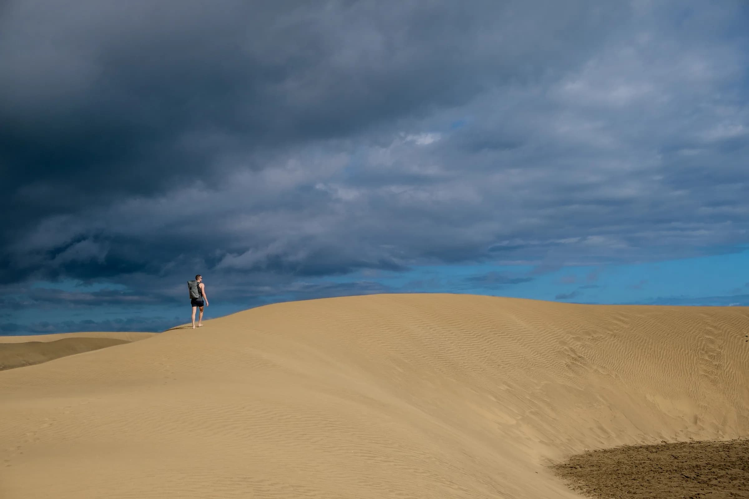 Dunes in Maspalomas beneath a cloudy sky