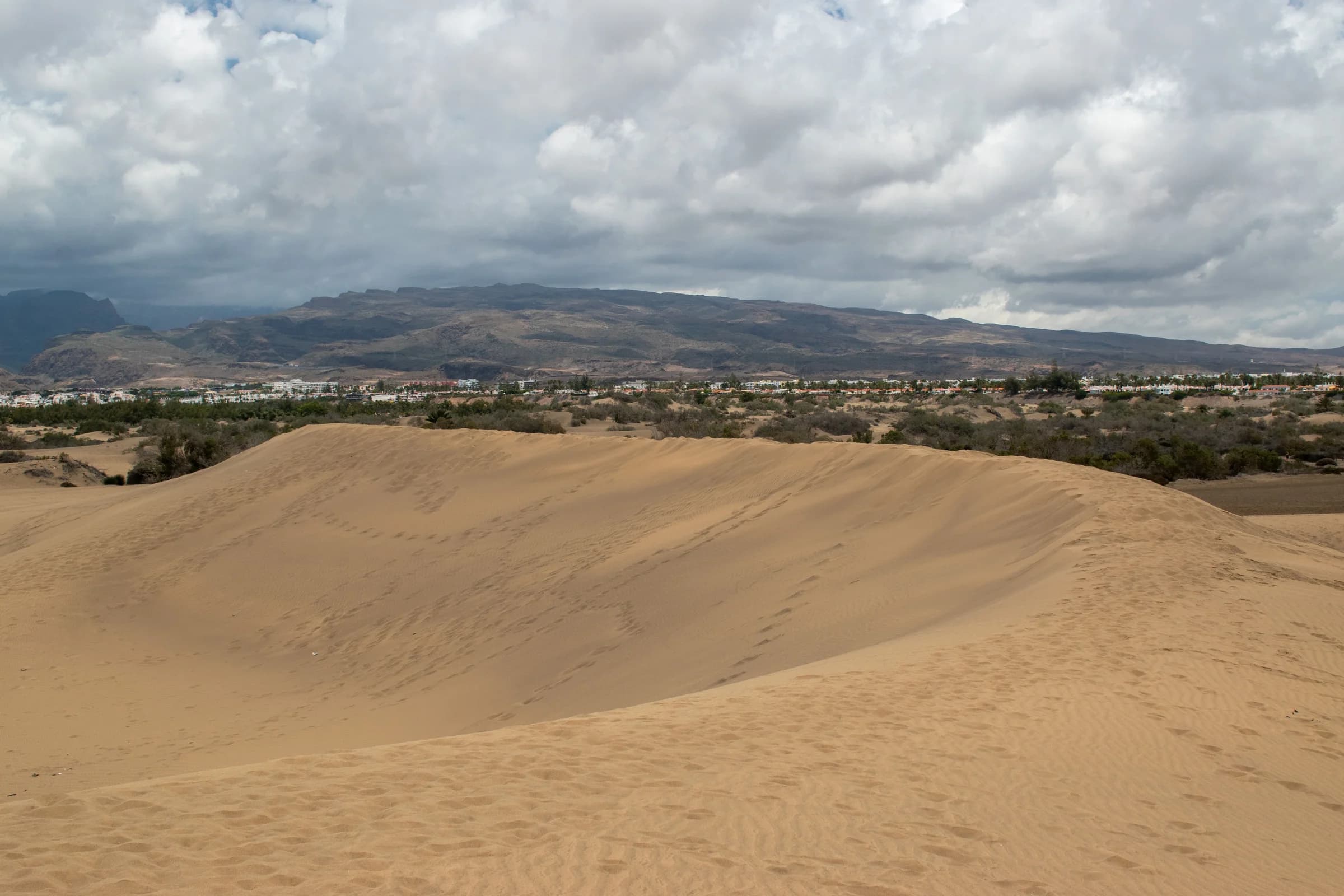 Gran Canaria sand dunes with the resort and mountains beyond